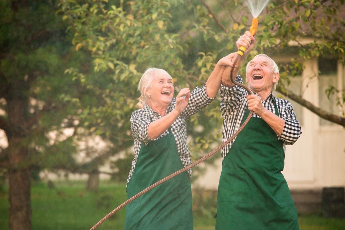 Joyful seniors gardening together
